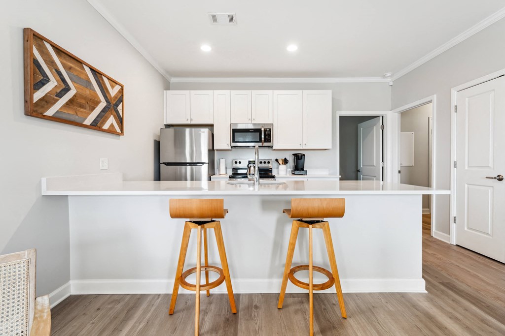 a kitchen with a counter top with two bar stools