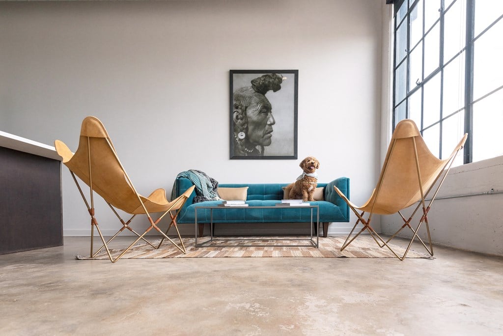 a sofa and two chairs in a living room