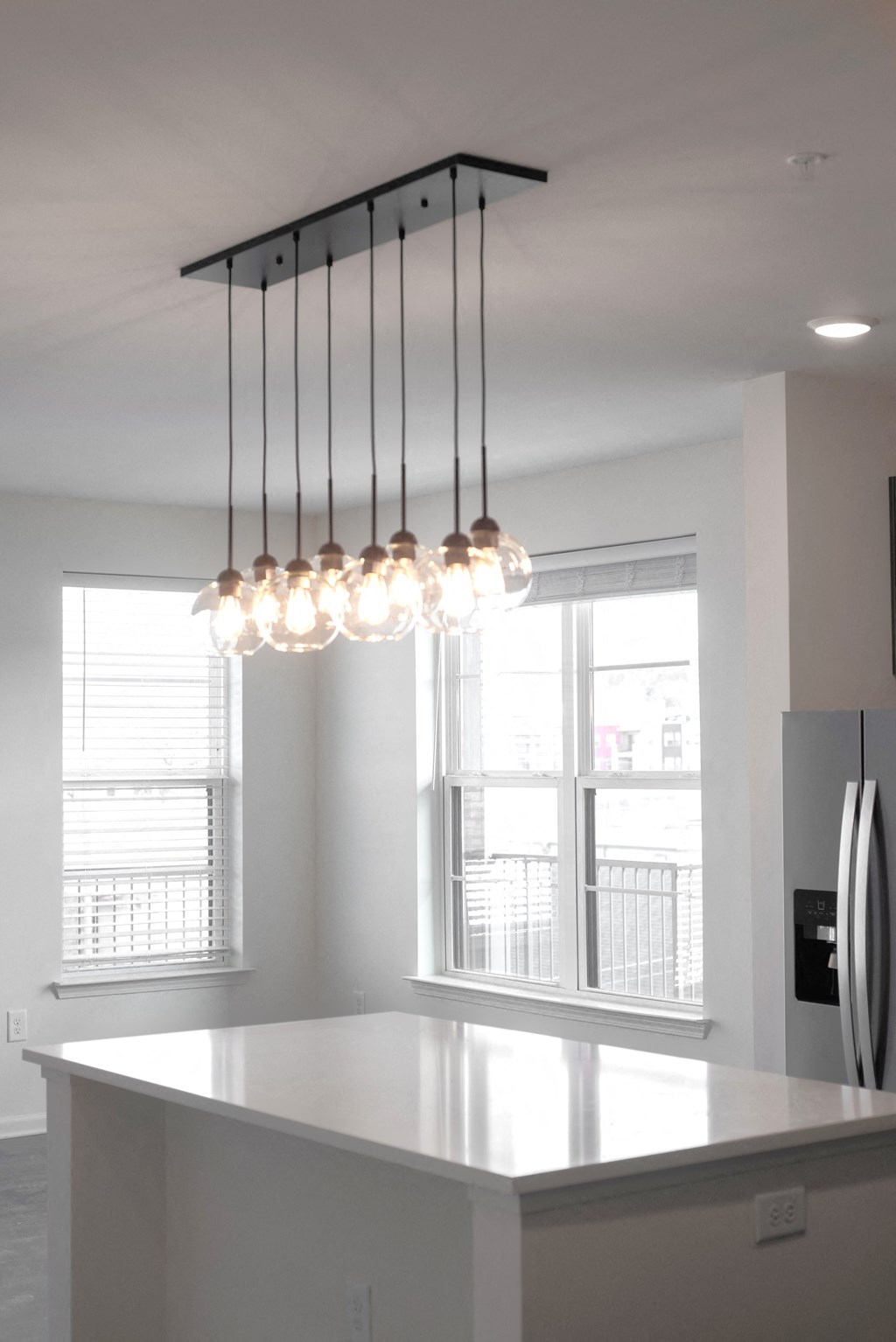 a kitchen with a counter top and a chandelier at Artisan Flats in Birmingham, AL