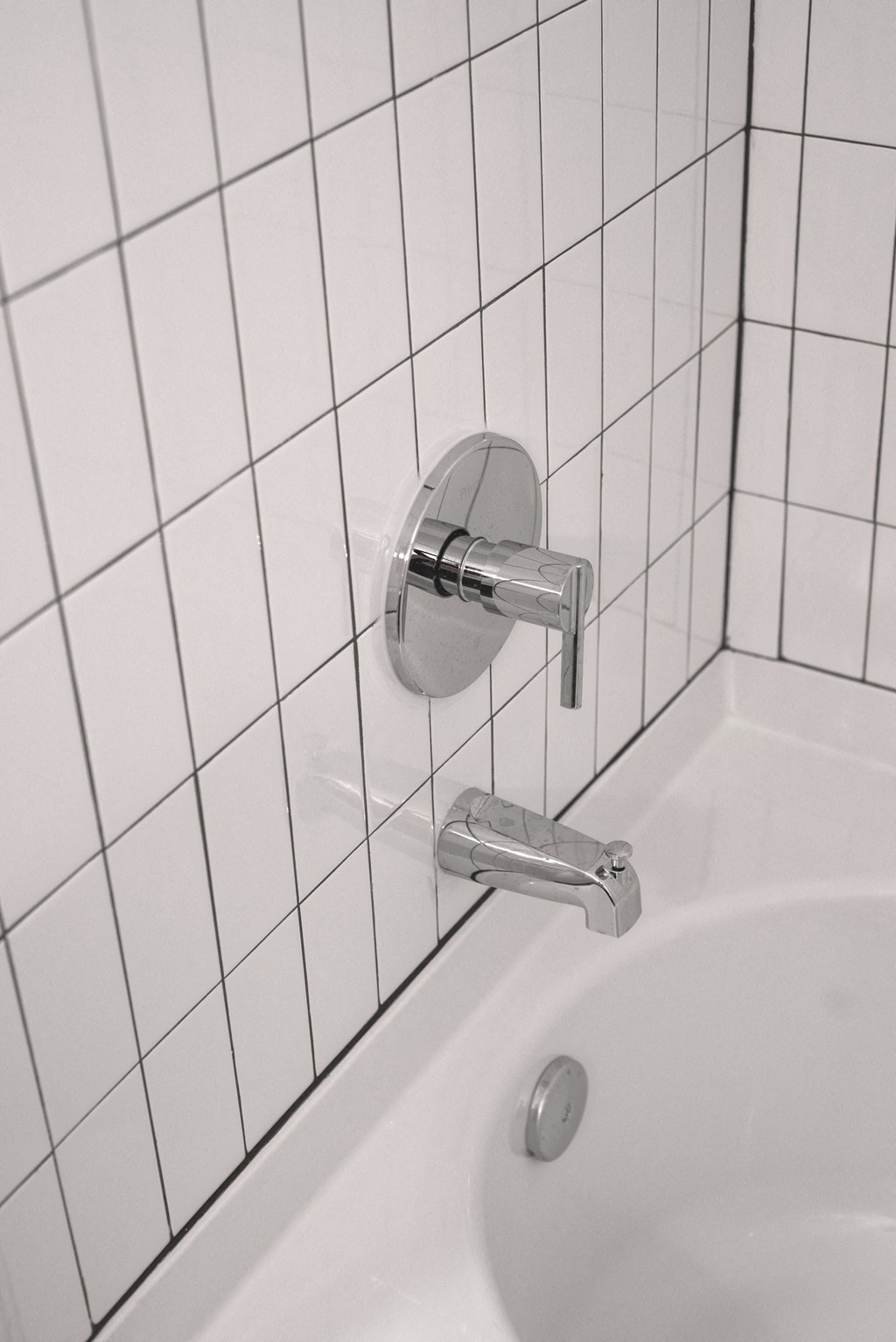 a white sink in a white tiled bathroom at Artisan Flats in Birmingham, AL