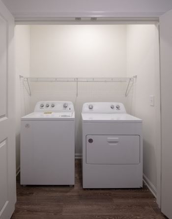 a washer and dryer in a room with a white wall at Artisan Flats in Birmingham, AL