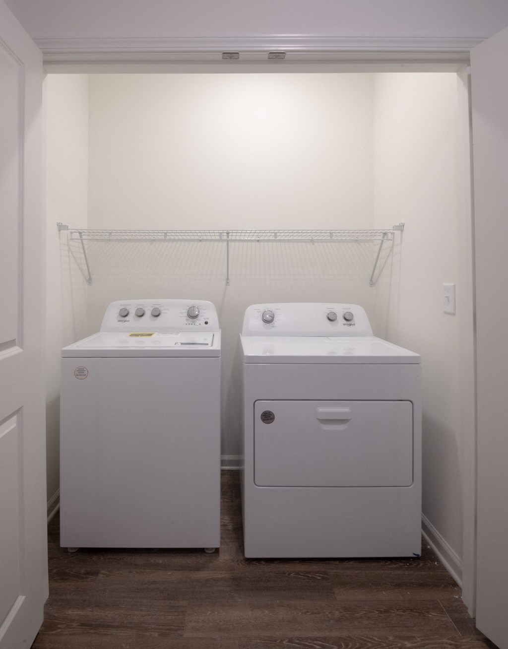 a washer and dryer in a room with a white wall at Artisan Flats in Birmingham, AL
