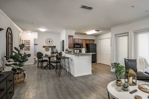 A modern kitchen with a dining table and chairs.