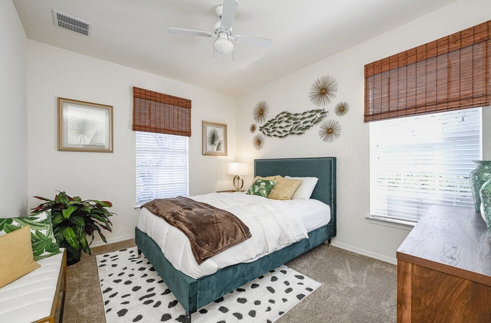 a bedroom with a bed and a ceiling fan