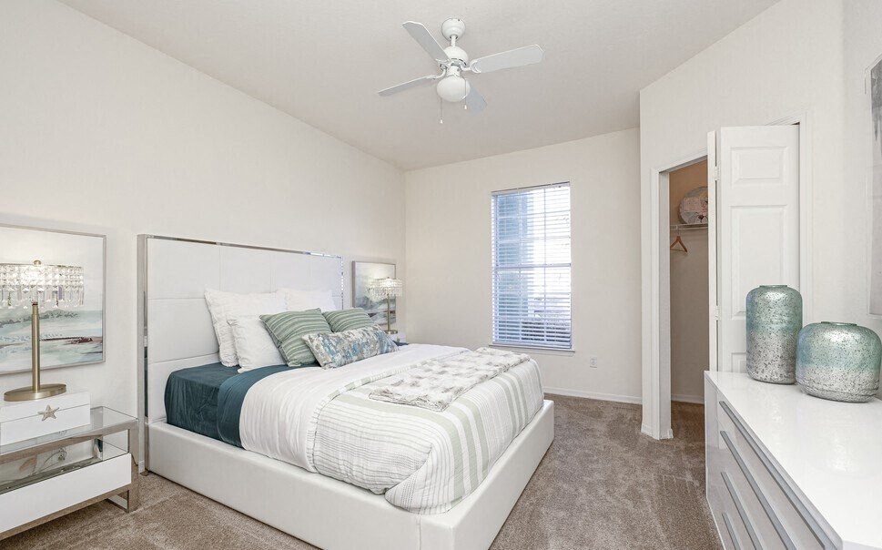 a bedroom with a bed and a ceiling fan