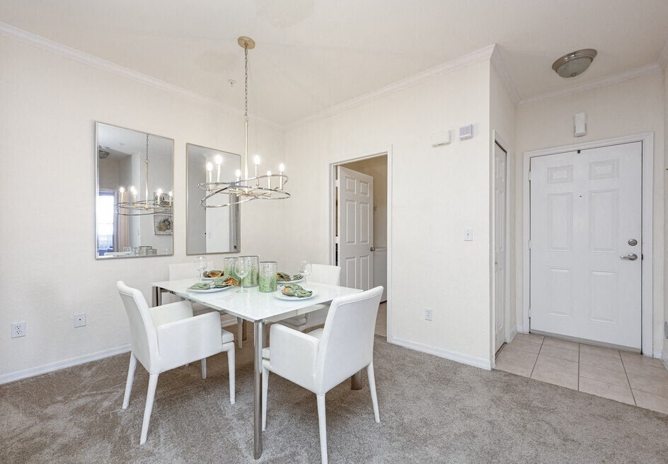 a dining room with a table and chairs