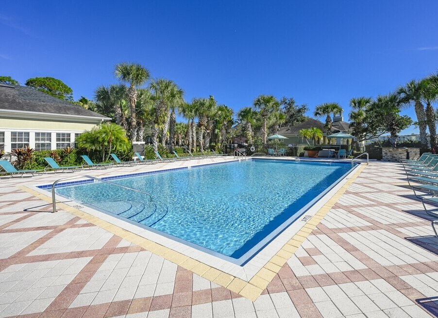 a large swimming pool with chairs around it