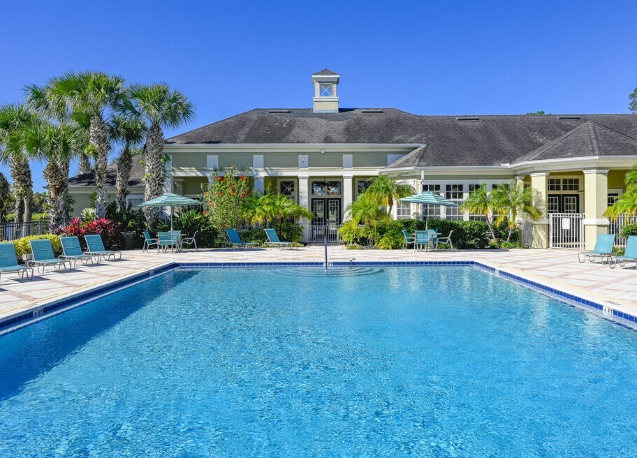 a large swimming pool in front of a house