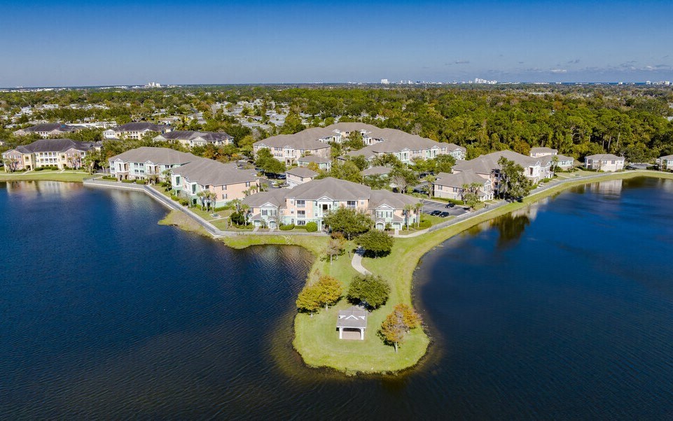 an aerial view of houses on the water near a lake