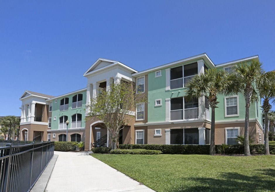 an exterior view of an apartment building with palm trees