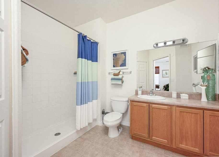 a bathroom with a toilet a sink and a shower