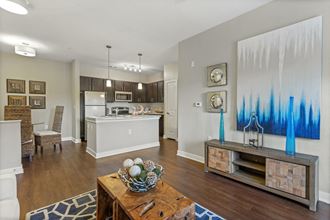 Spacious Living Room and Kitchen with Stainless Steel Appliances  at Hampton Roads Crossing Apartments in Suffolk, VA - Photo Gallery 4