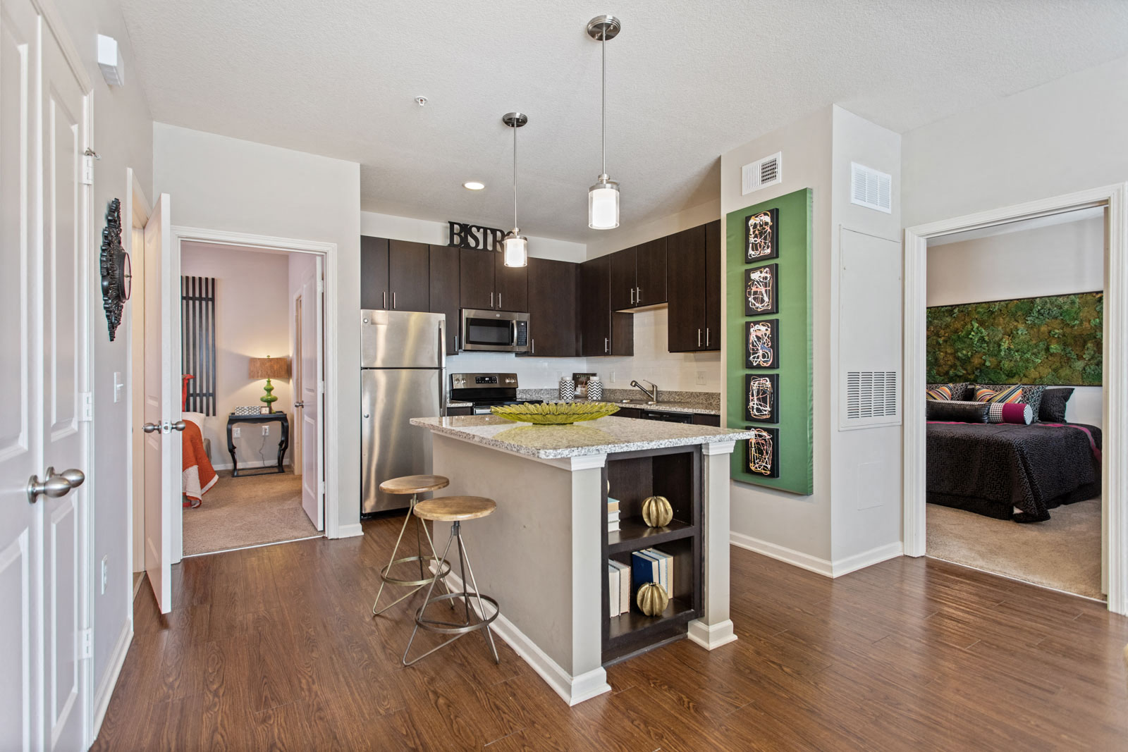 a kitchen with a bar and a living room with a couch