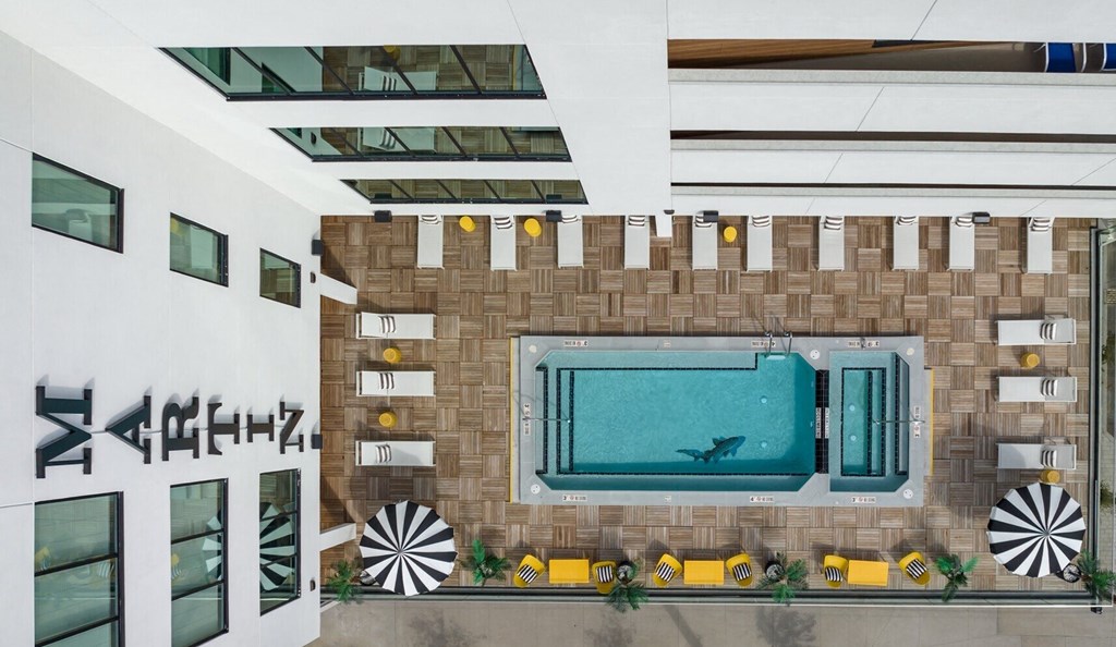 the lobby of a hotel with a pool and a window
