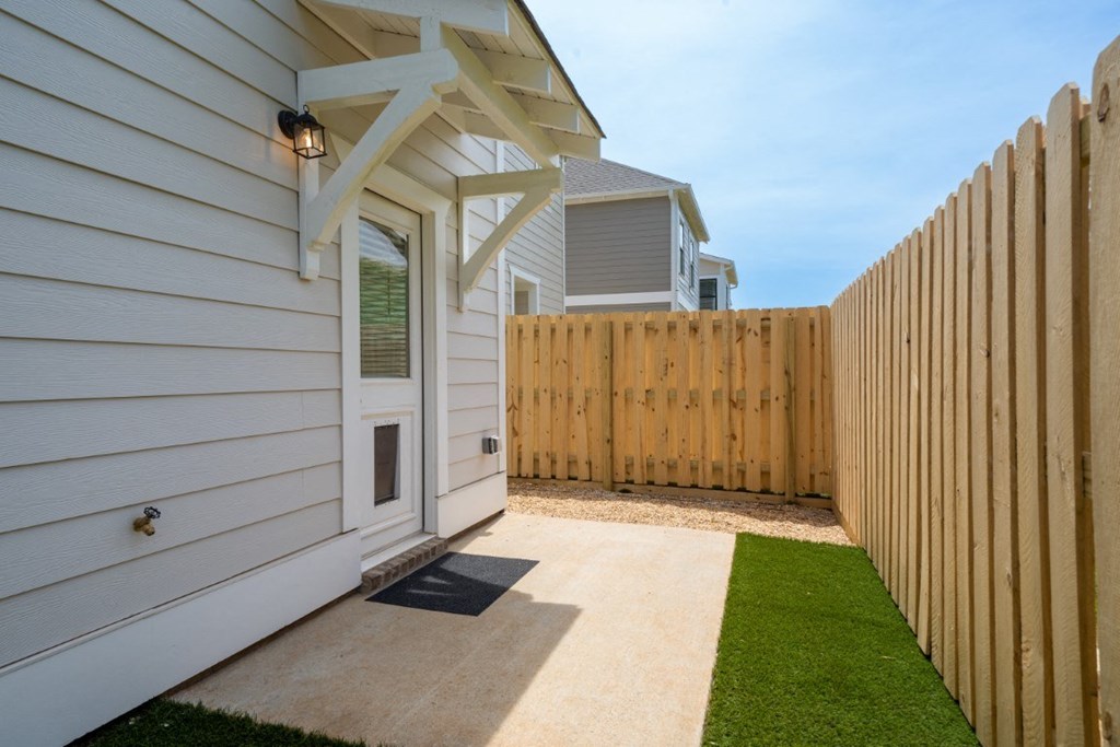 A townhouse with a fenced backyard and side yard.