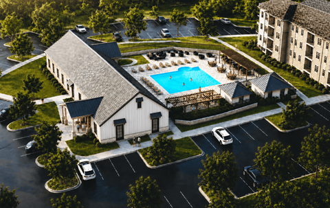 A large white building with a pool in front.