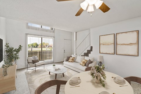 A living room with a dining table set for two.