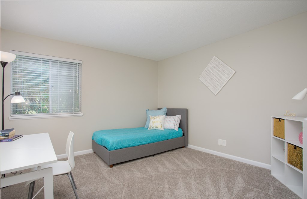 Guest bedroom with large window at Malibu at Martin Apartments in Huntsville, Alabama