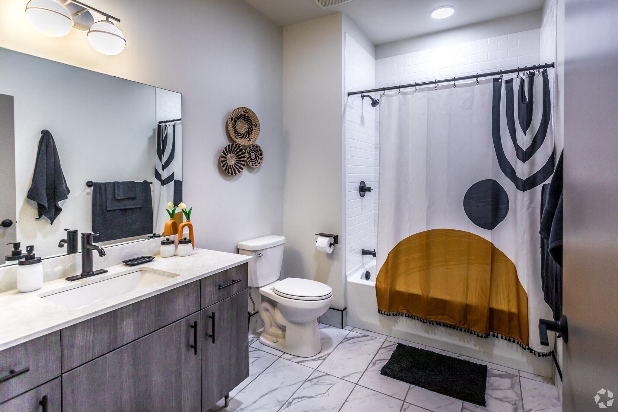a bathroom with a shower and a sink and a toilet