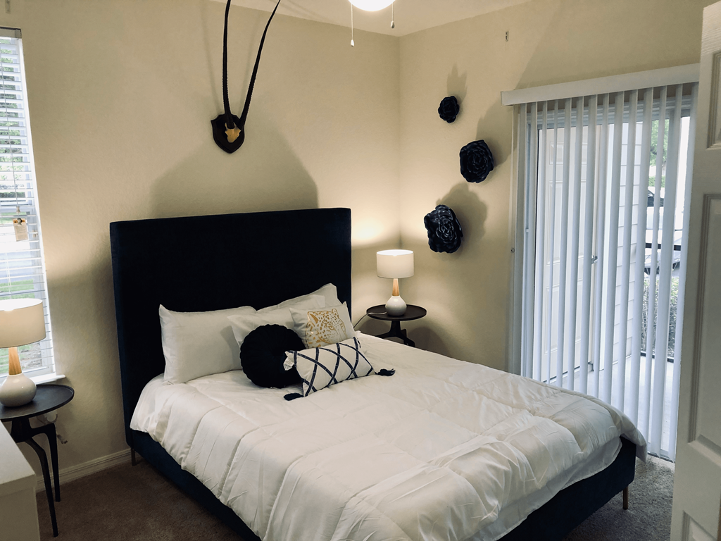 a bedroom with a large bed and a large window