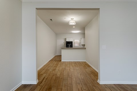 A room with wooden floors and white walls.