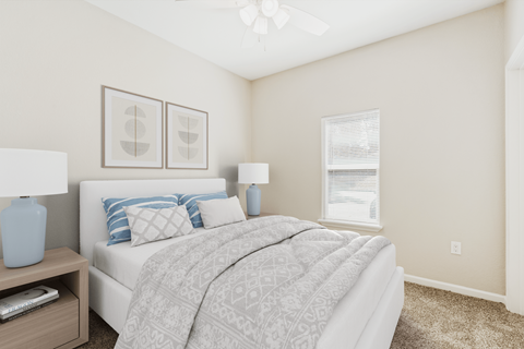 A bedroom with a bed, nightstand, and two framed pictures on the wall.
