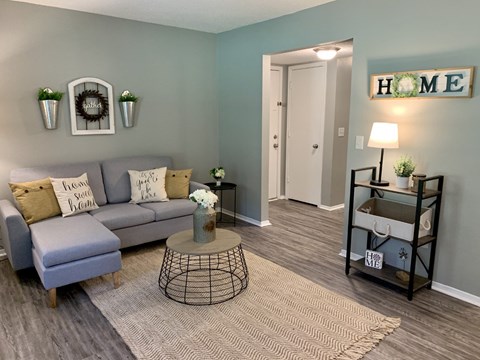 A living room with a grey sofa and a coffee table.