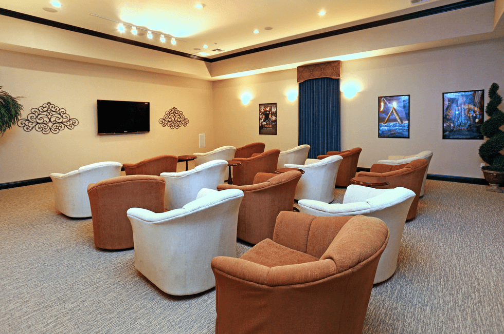 a conference room with chairs and a television