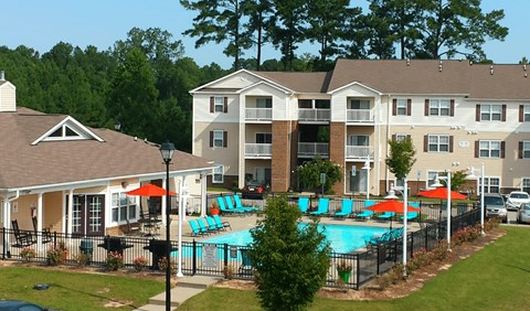 Exterior of a modern apartment community in Fayetteville NC with a pool