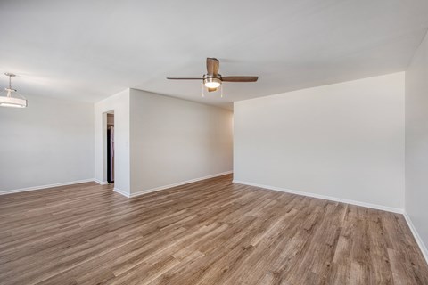 A room with a ceiling fan and light fixture.