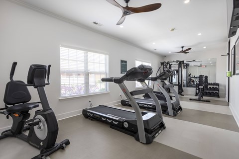 A spacious home gym with a variety of exercise equipment.