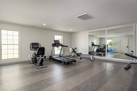 A spacious home gym with a variety of exercise equipment.