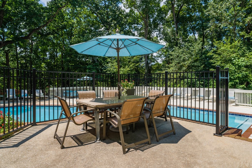 Poolside umbrella shaded table at Summerchase at Riverchase in Hoover, Alabama.