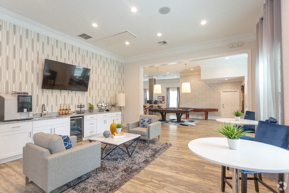 a clubroom with a table and chairs and a television