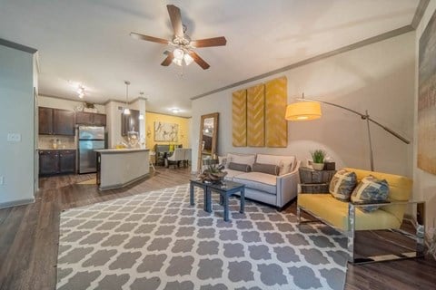 a living room with a couch and a ceiling fan