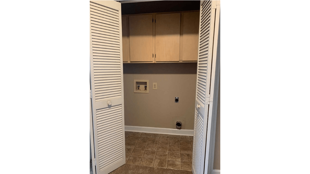 the closet in the laundry room is open to the living room