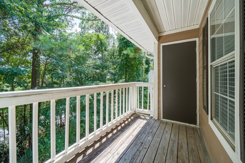 A wooden patio balcony surrounded by trees at Summerchase at Riverchase in Hoover, Alabama