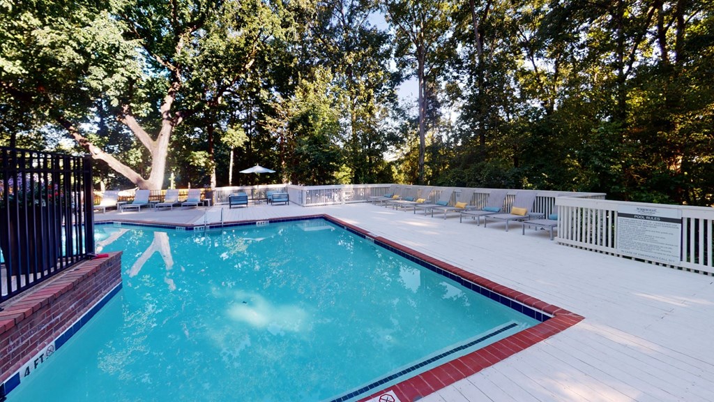 Sparkling pool with expansive sundeck and chaise lounges at Summerchase at Riverchase in Hoover, AL