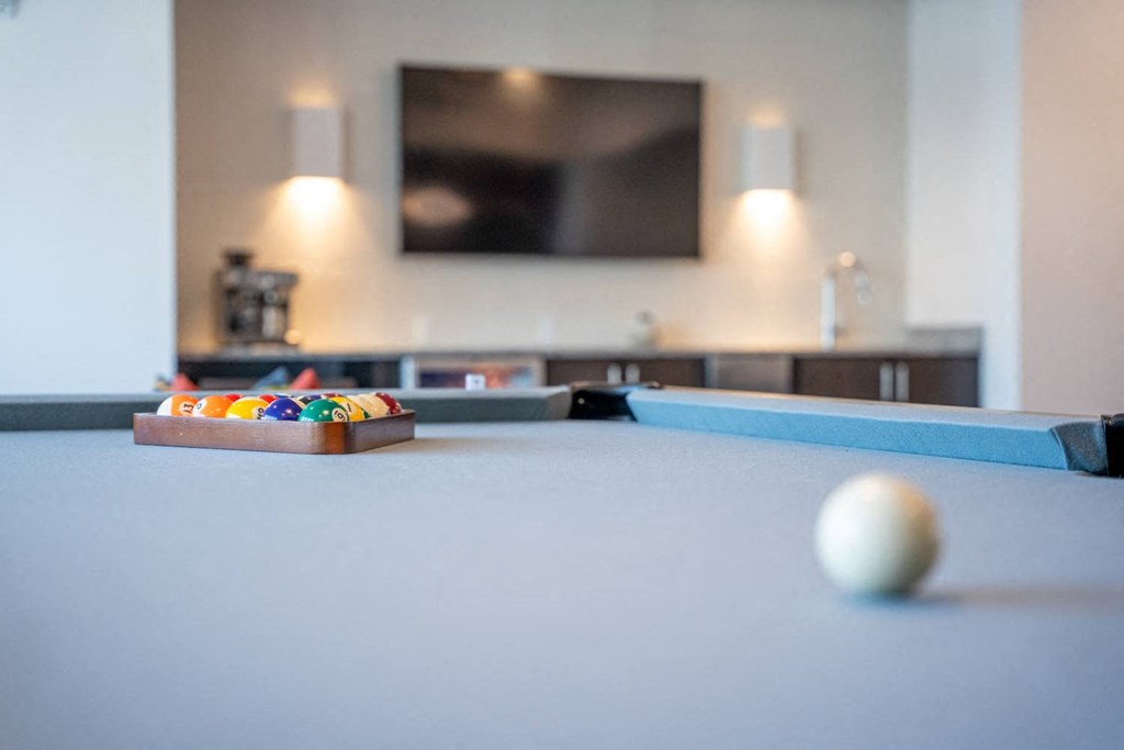 a pool table in a living room with a tv at 20 Midtown, Birmingham, 35233
