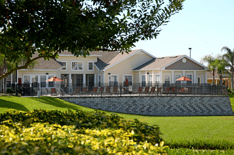a large house with a pool in front of it