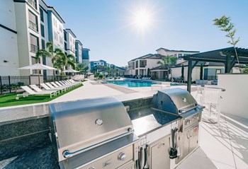 Grilling Station Outdoor BBQ and picnic area with grilling stations at The Pointe on Westshore apartment rentals in Tampa, FL - Photo Gallery 4