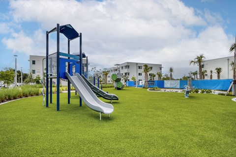 A playground with a blue and white slide.