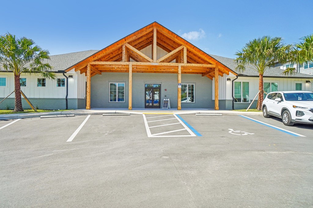 a parking lot in front of a building with a car parked