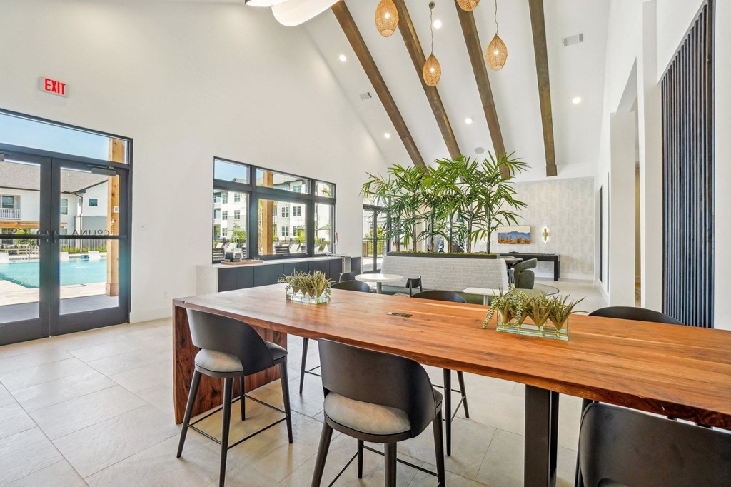 a dining room with a wooden table and chairs