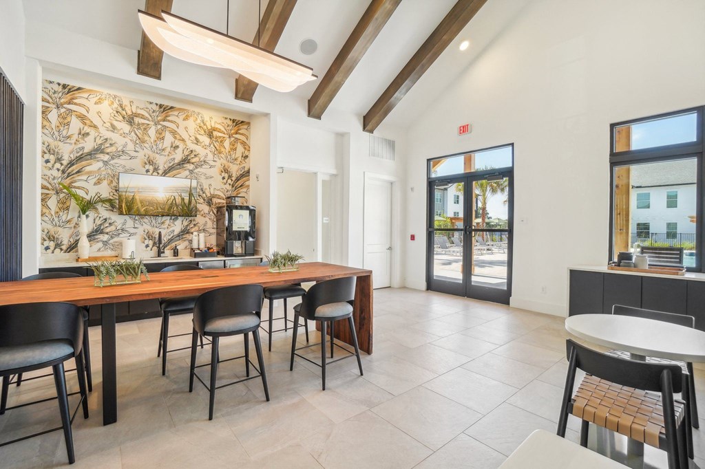 a dining room with a wooden table and chairs     and a bar