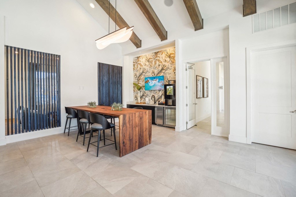a dining room with a wooden table and chairs