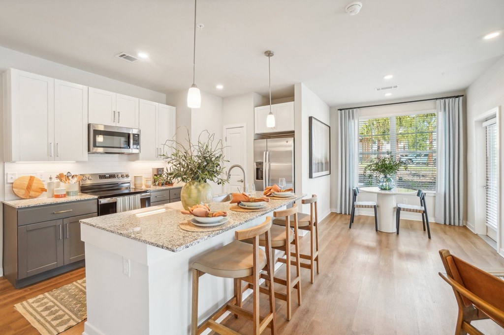 an open kitchen and dining area with a table and chairs