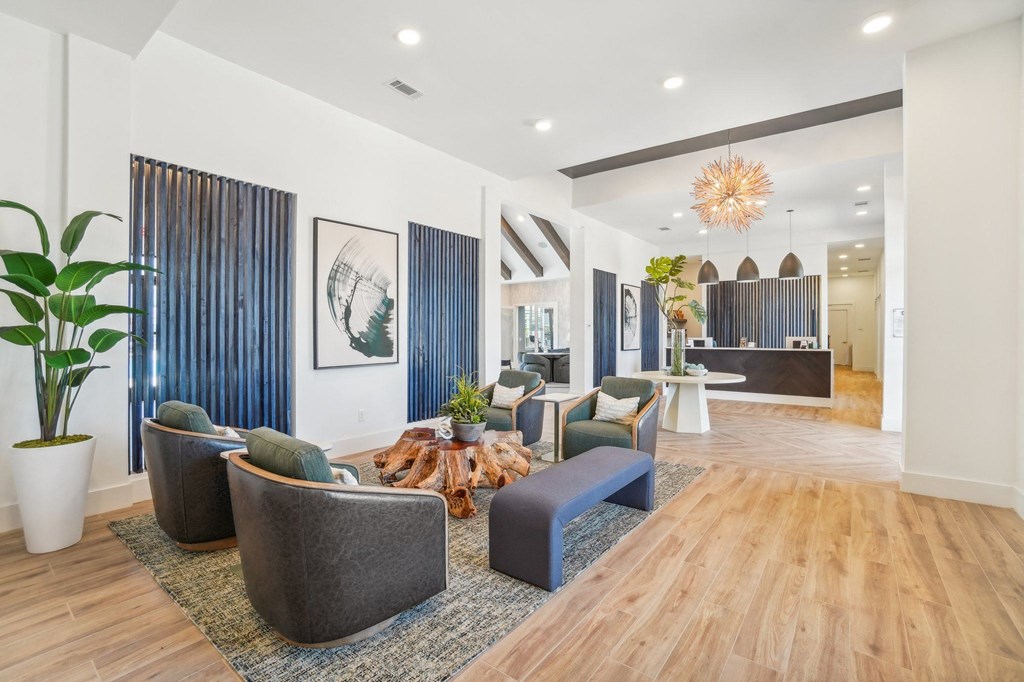 a living room with couches and chairs and a table