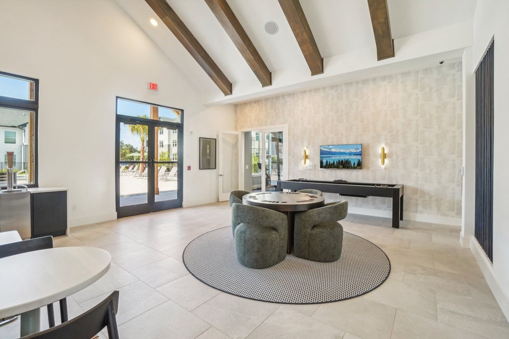 a living room with a round table and a fireplace