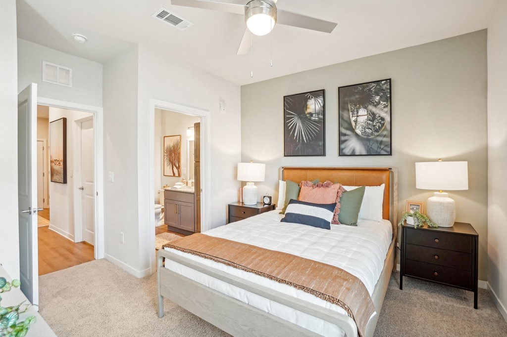 a bedroom with a bed and a ceiling fan